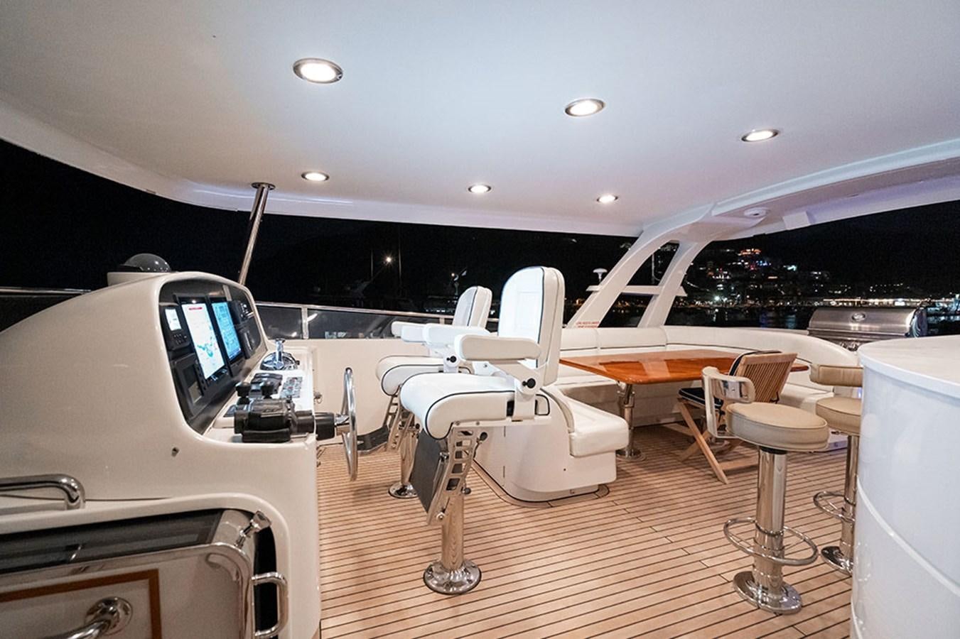 a room with a table and chairs aboard WICKED COOL Yacht for Sale