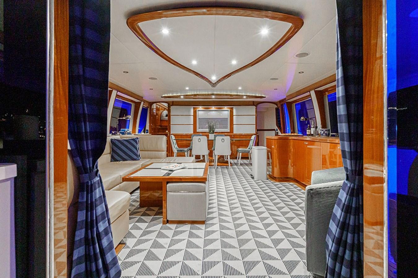 a room with a table chairs and a window aboard WICKED COOL Yacht for Sale