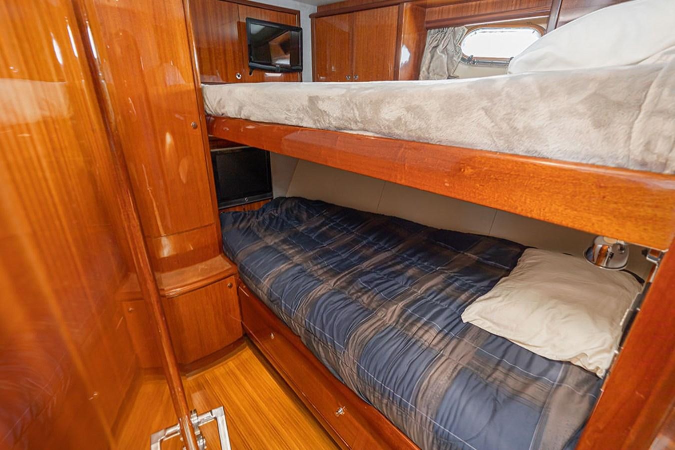 a bed with a blue sheet aboard WICKED COOL Yacht for Sale