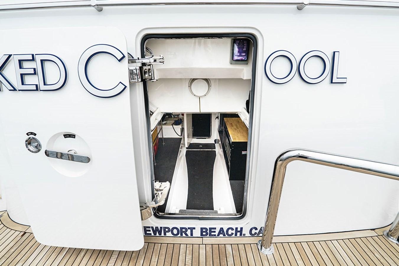 a white machine with a black and white logo on the side aboard WICKED COOL Yacht for Sale