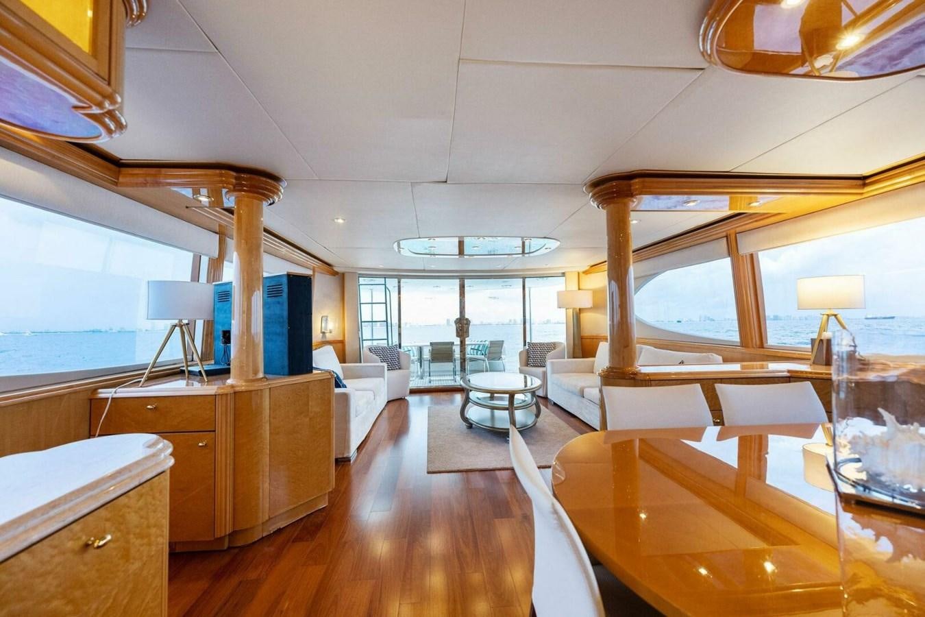 a room with a wood floor and a large window with a desk and a tv on it aboard NORDLYS Yacht for Sale
