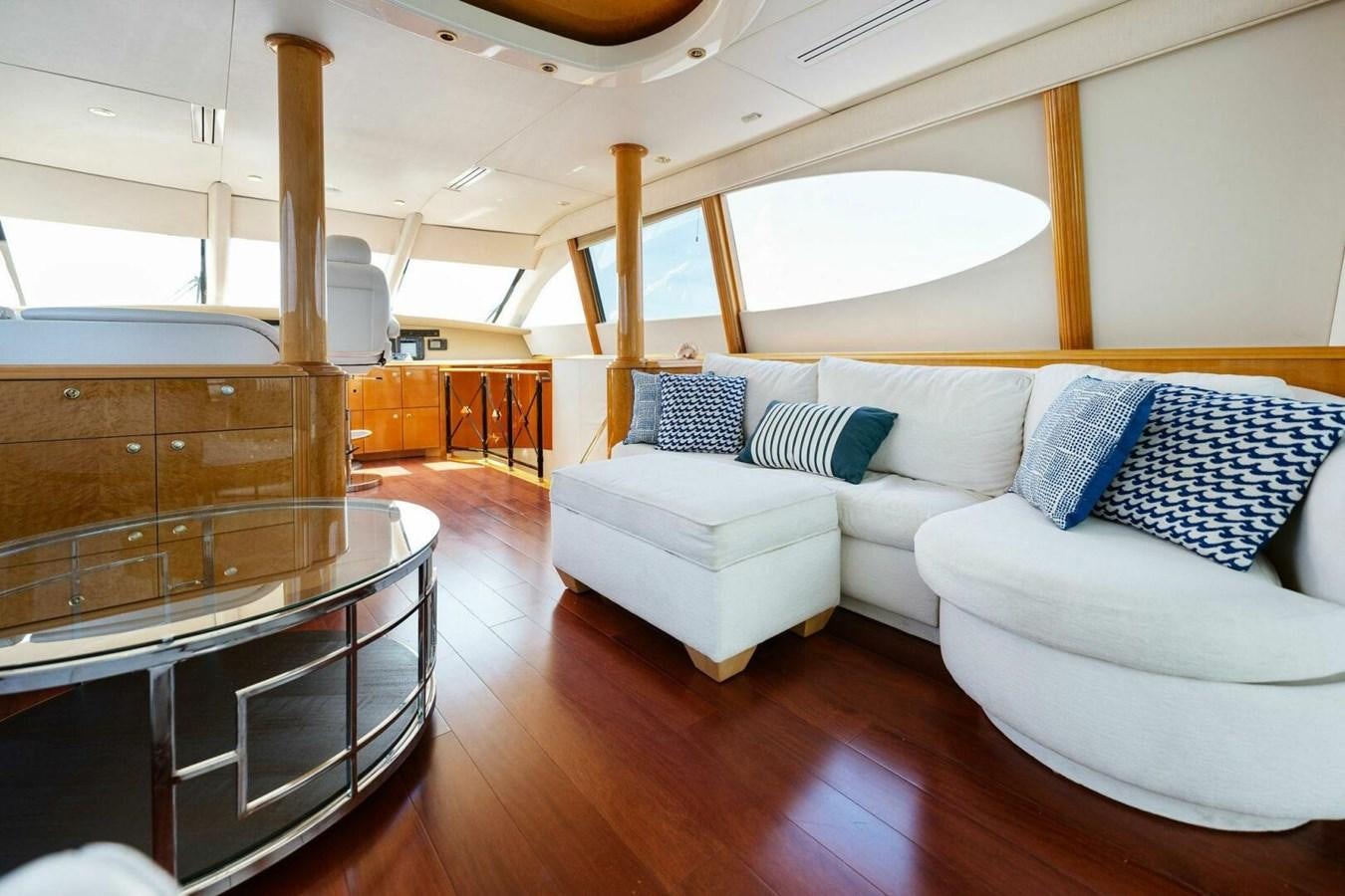 a living room with a white couch and a wood table aboard NORDLYS Yacht for Sale