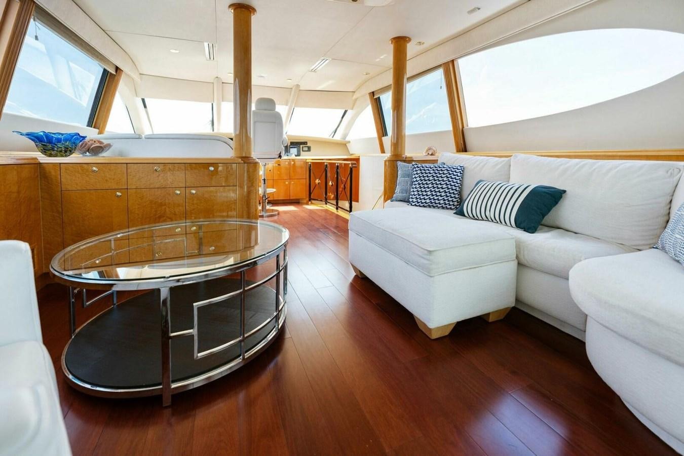 a living room with a large glass table and a couch aboard NORDLYS Yacht for Sale