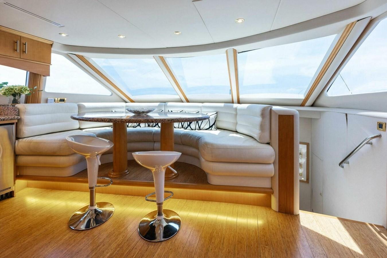 a living room with a table and chairs aboard NORDLYS Yacht for Sale