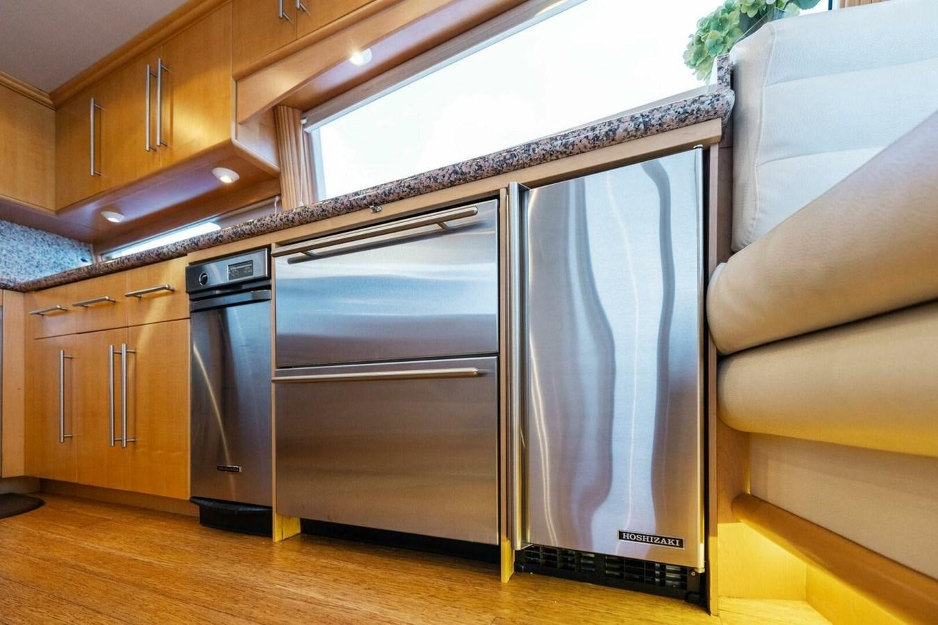 a kitchen with a large refrigerator aboard NORDLYS Yacht for Sale