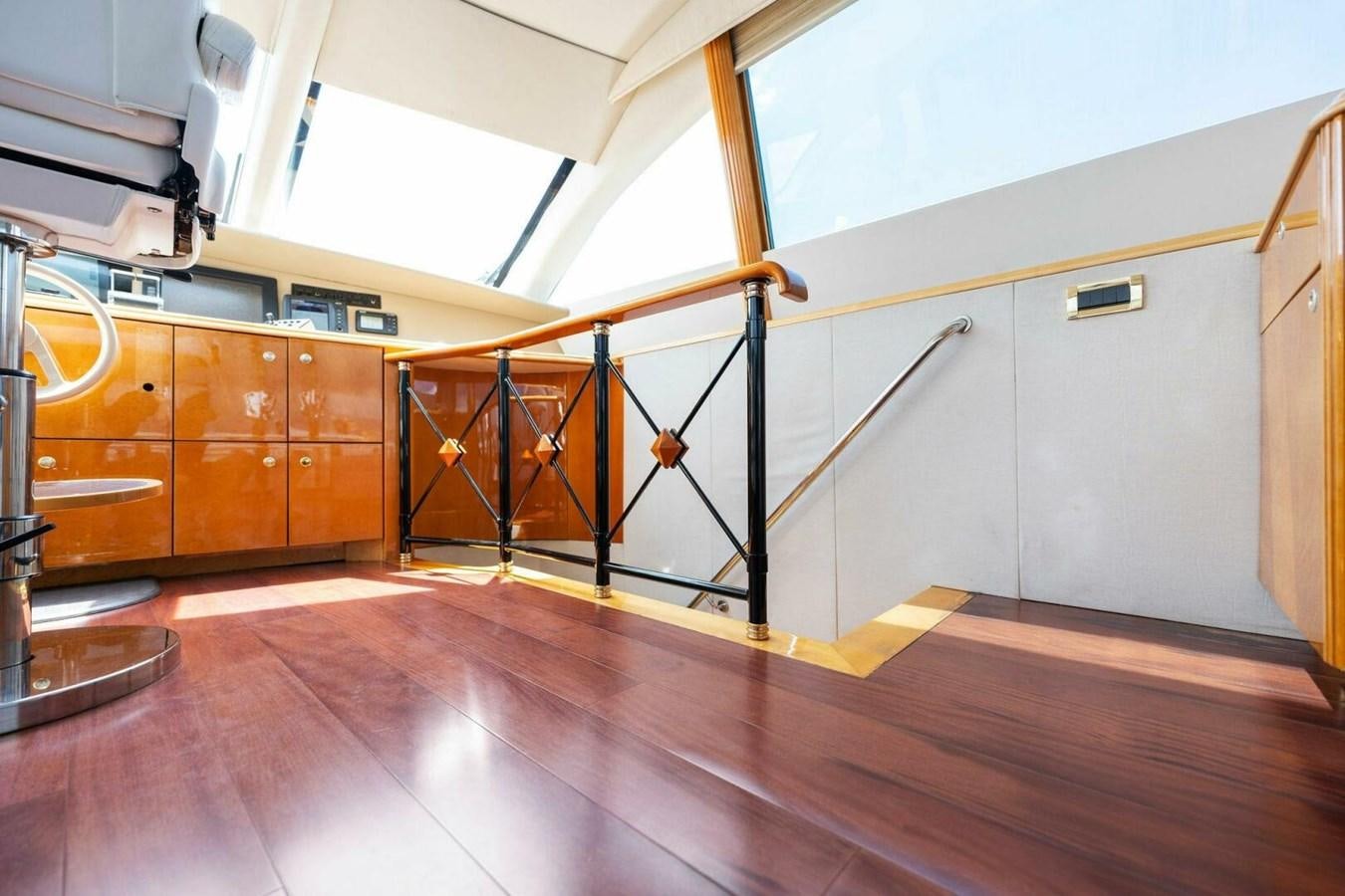 a room with wooden floors and a staircase aboard NORDLYS Yacht for Sale