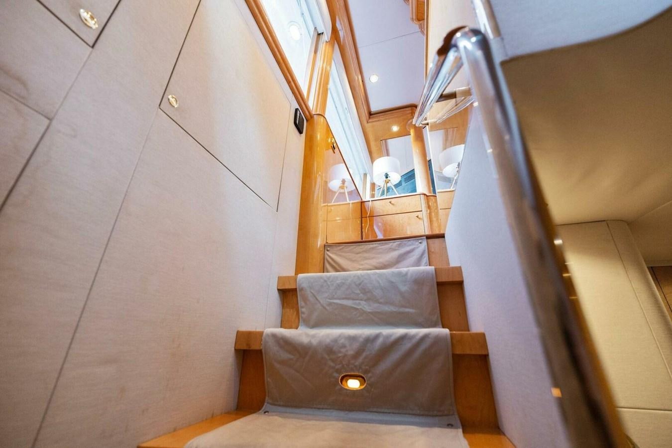 a wooden staircase with a wood railing aboard NORDLYS Yacht for Sale