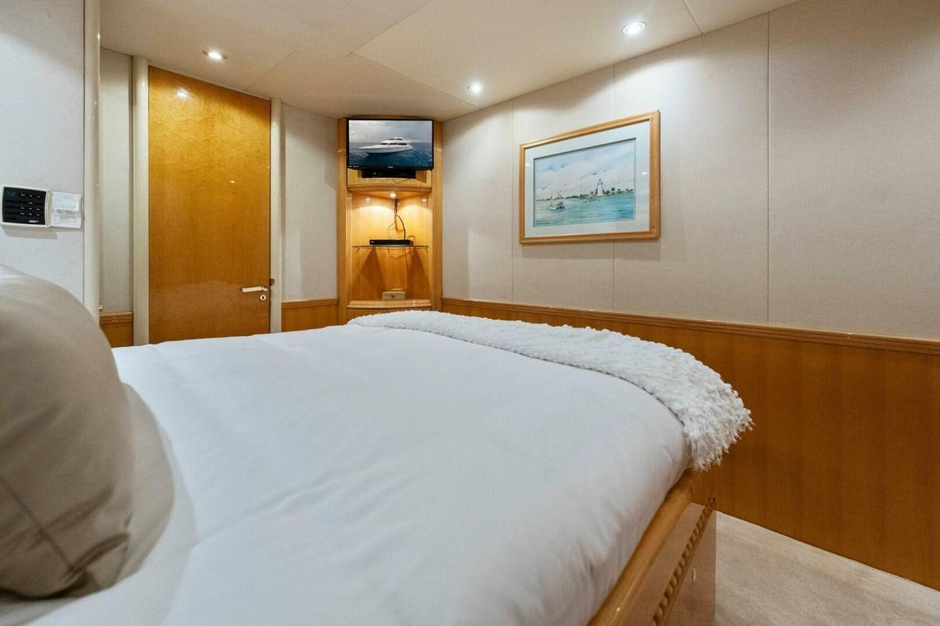 a room with a bed and a television on the wall aboard NORDLYS Yacht for Sale