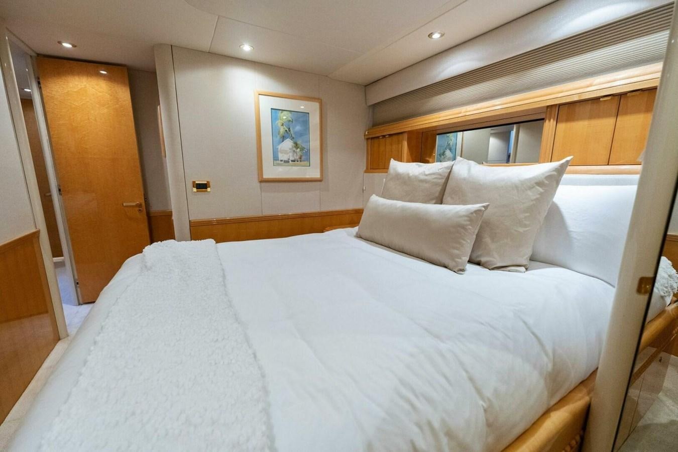 a bed with white sheets aboard NORDLYS Yacht for Sale