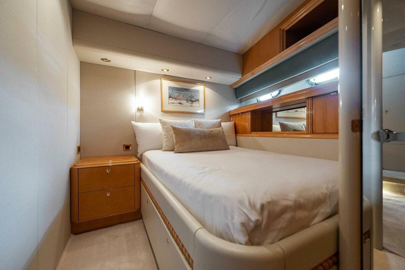 a bedroom with a bed and a dresser aboard NORDLYS Yacht for Sale