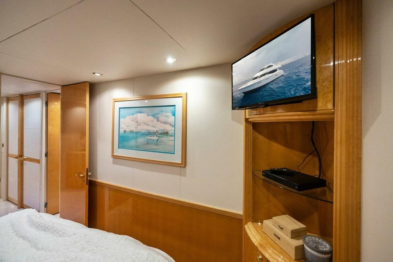 a bedroom with a television on the wall aboard NORDLYS Yacht for Sale