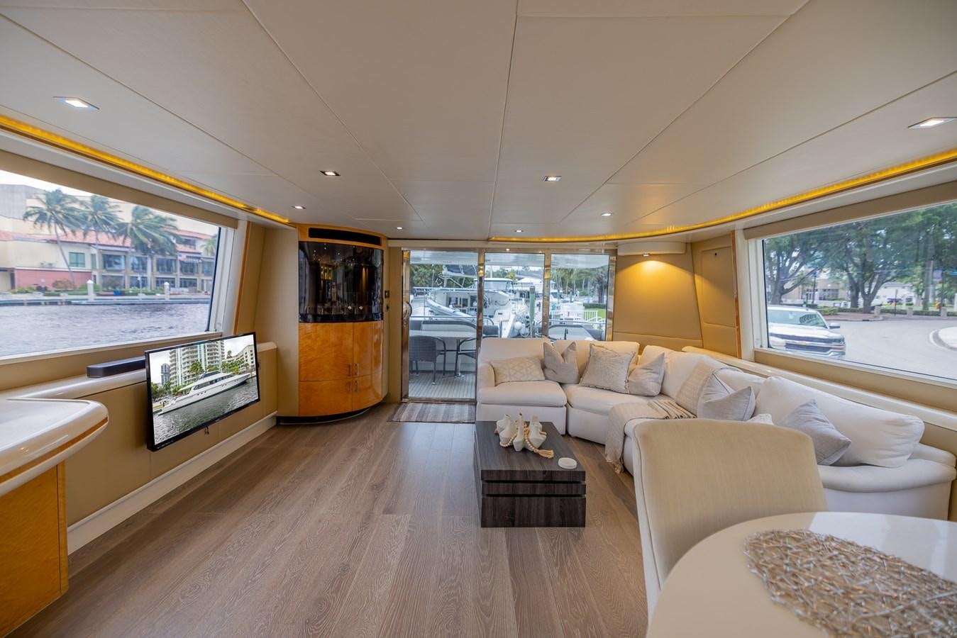a living room with a large window aboard BOURBON LEGEND Yacht for Sale