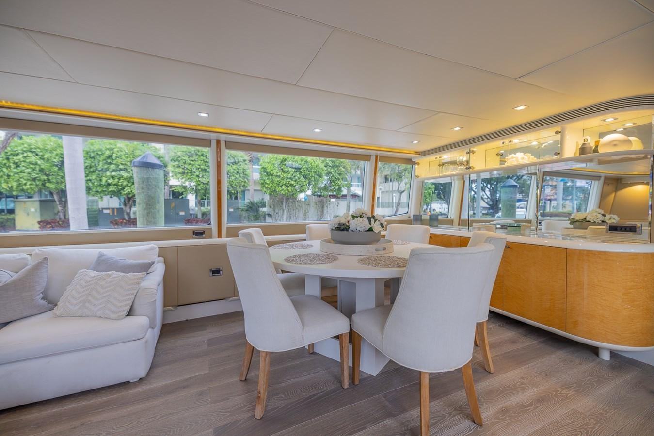 a room with a table chairs and a couch aboard BOURBON LEGEND Yacht for Sale