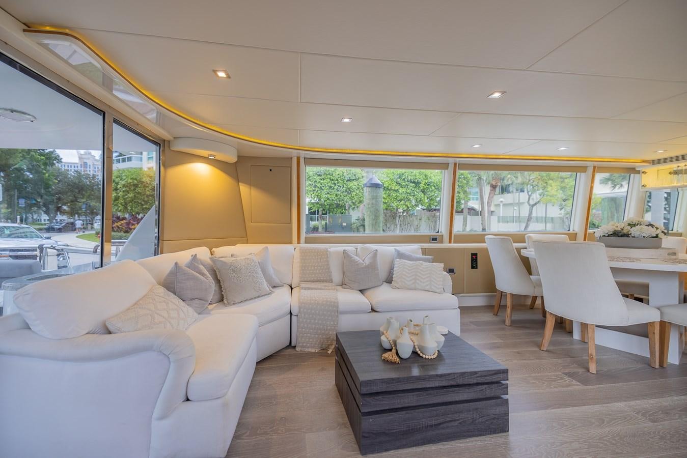 a living room with a large window aboard BOURBON LEGEND Yacht for Sale