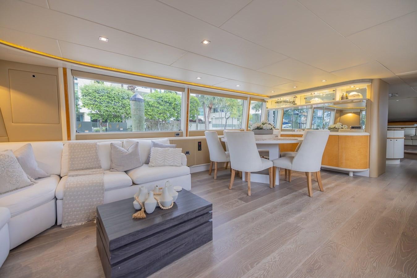 a living room with a couch and a table aboard BOURBON LEGEND Yacht for Sale