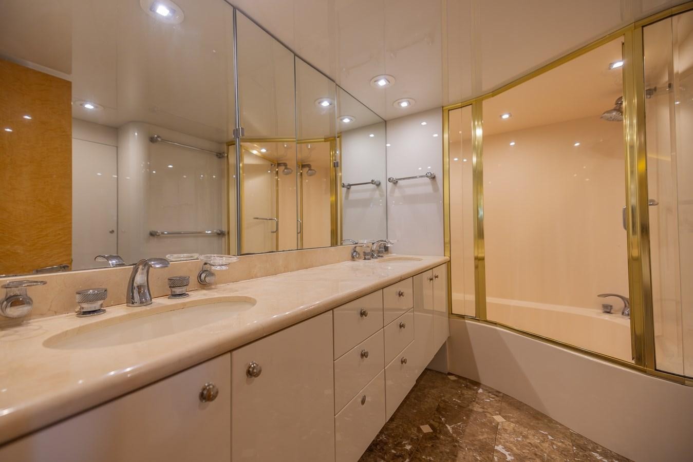 a bathroom with a large mirror aboard BOURBON LEGEND Yacht for Sale