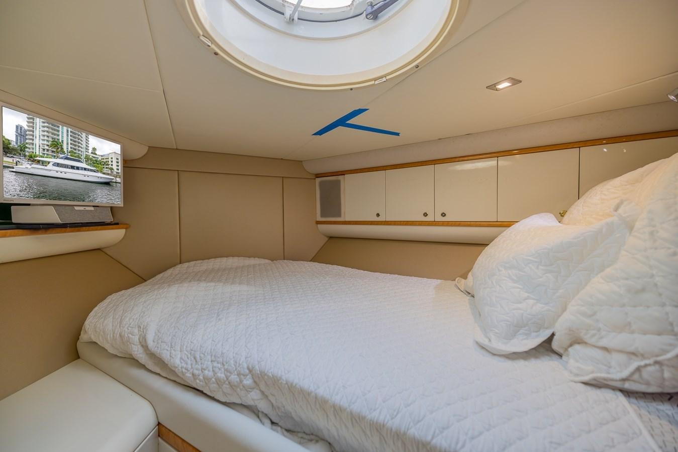a bed with white sheets aboard BOURBON LEGEND Yacht for Sale