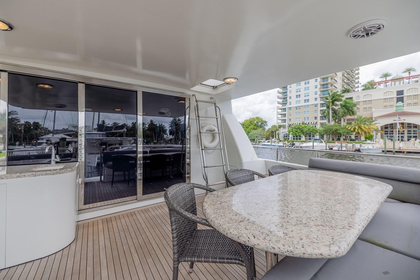 a table and chairs on a deck aboard BOURBON LEGEND Yacht for Sale
