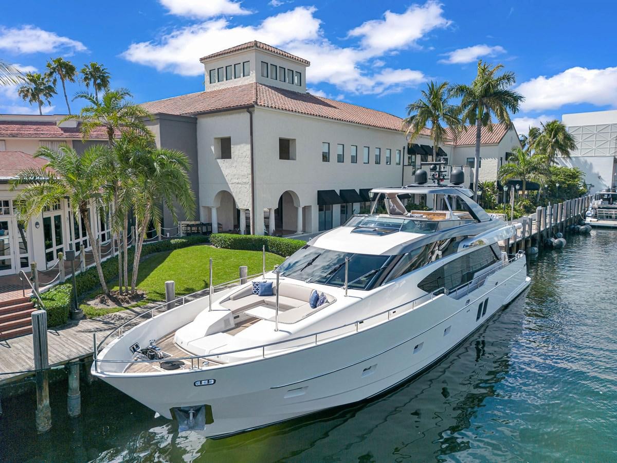 a white boat docked in a harbor aboard SL86/728 Yacht for Sale