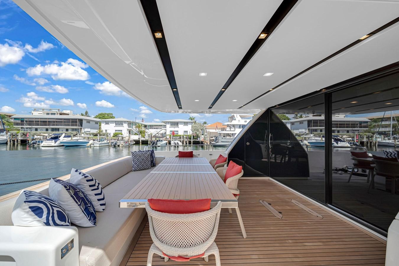 a deck with chairs and a body of water in the background aboard SL86/728 Yacht for Sale