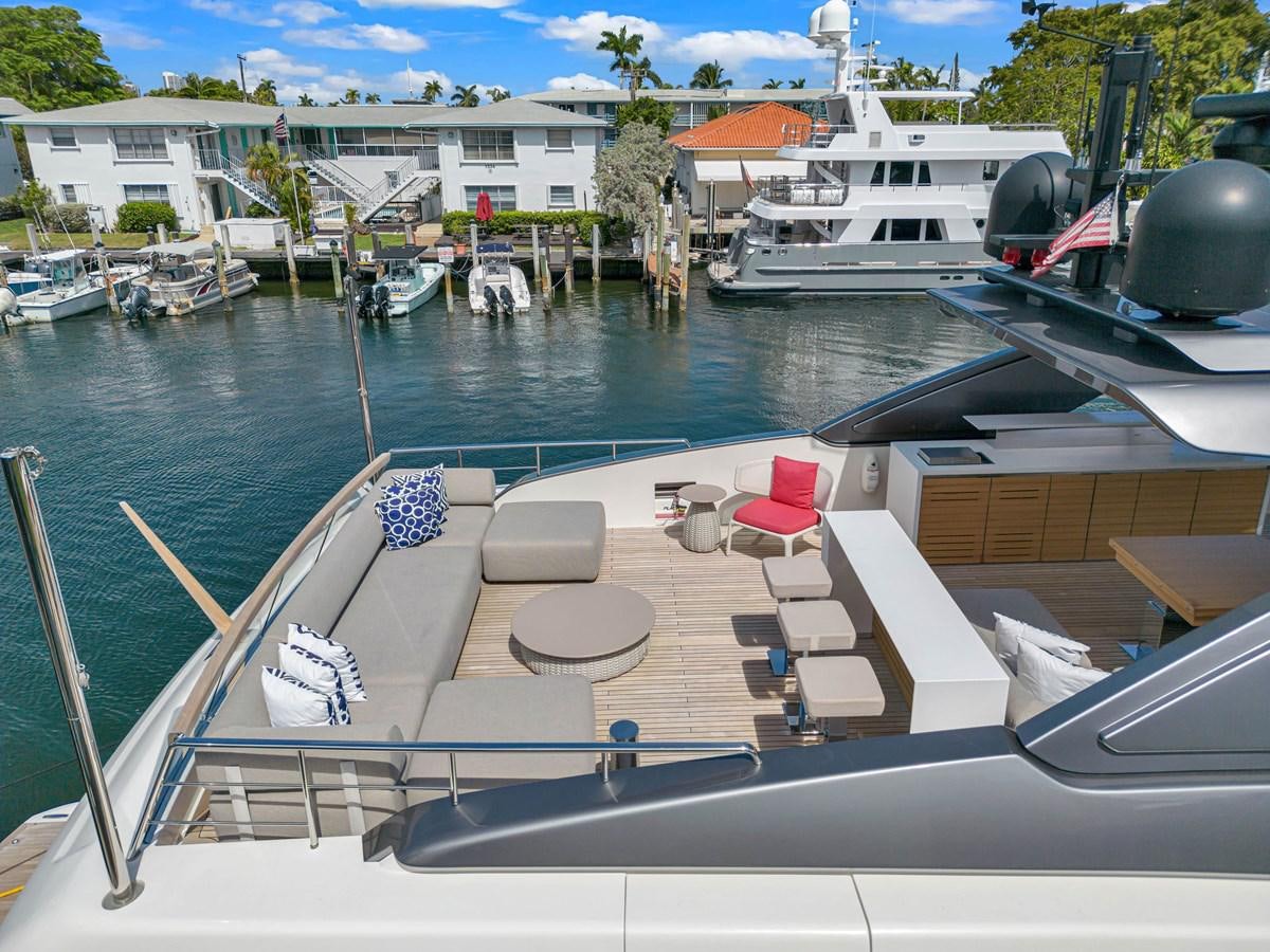 a deck with chairs and tables on it next to a body of water aboard SL86/728 Yacht for Sale