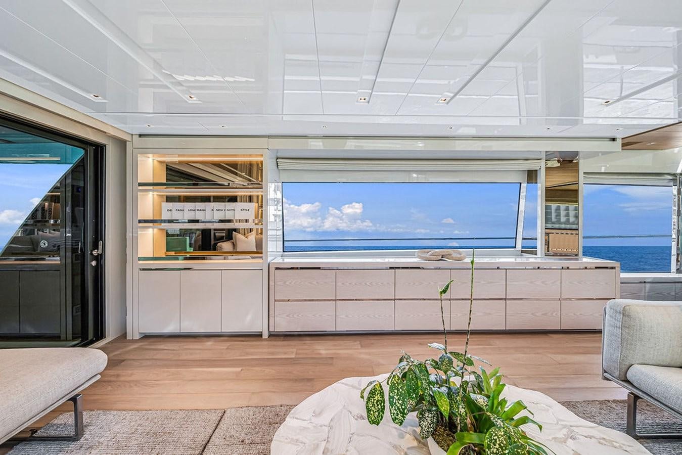 a room with a large window and a table and chairs aboard SL86/728 Yacht for Sale