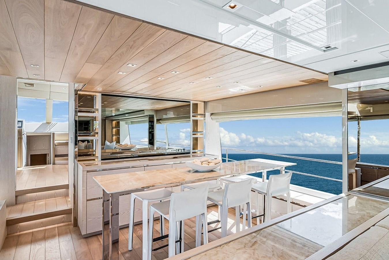 a large open space with a table and chairs and a large window aboard SL86/728 Yacht for Sale
