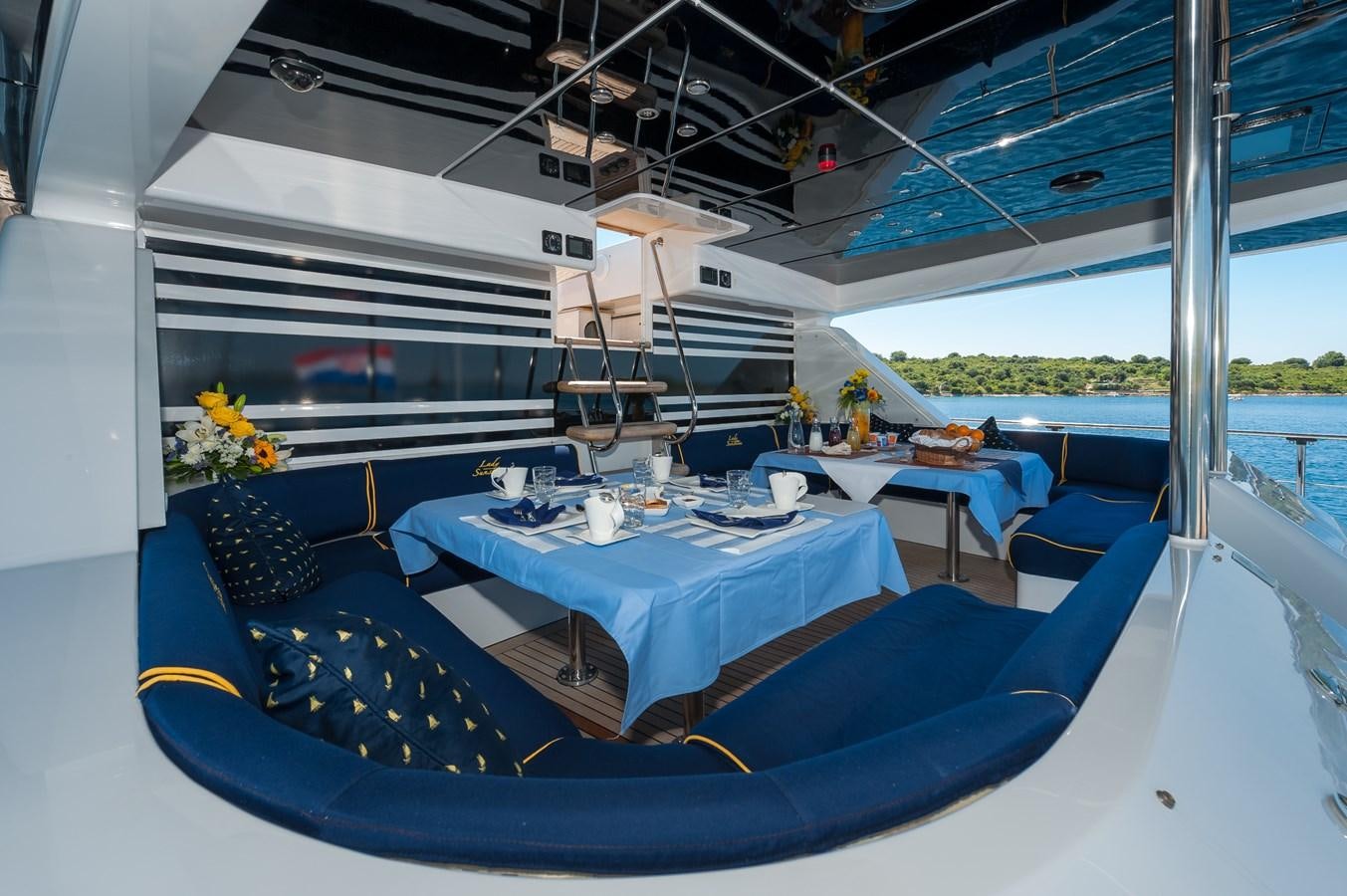 a boat with tables and chairs aboard LADY SUNSHINE Yacht for Sale