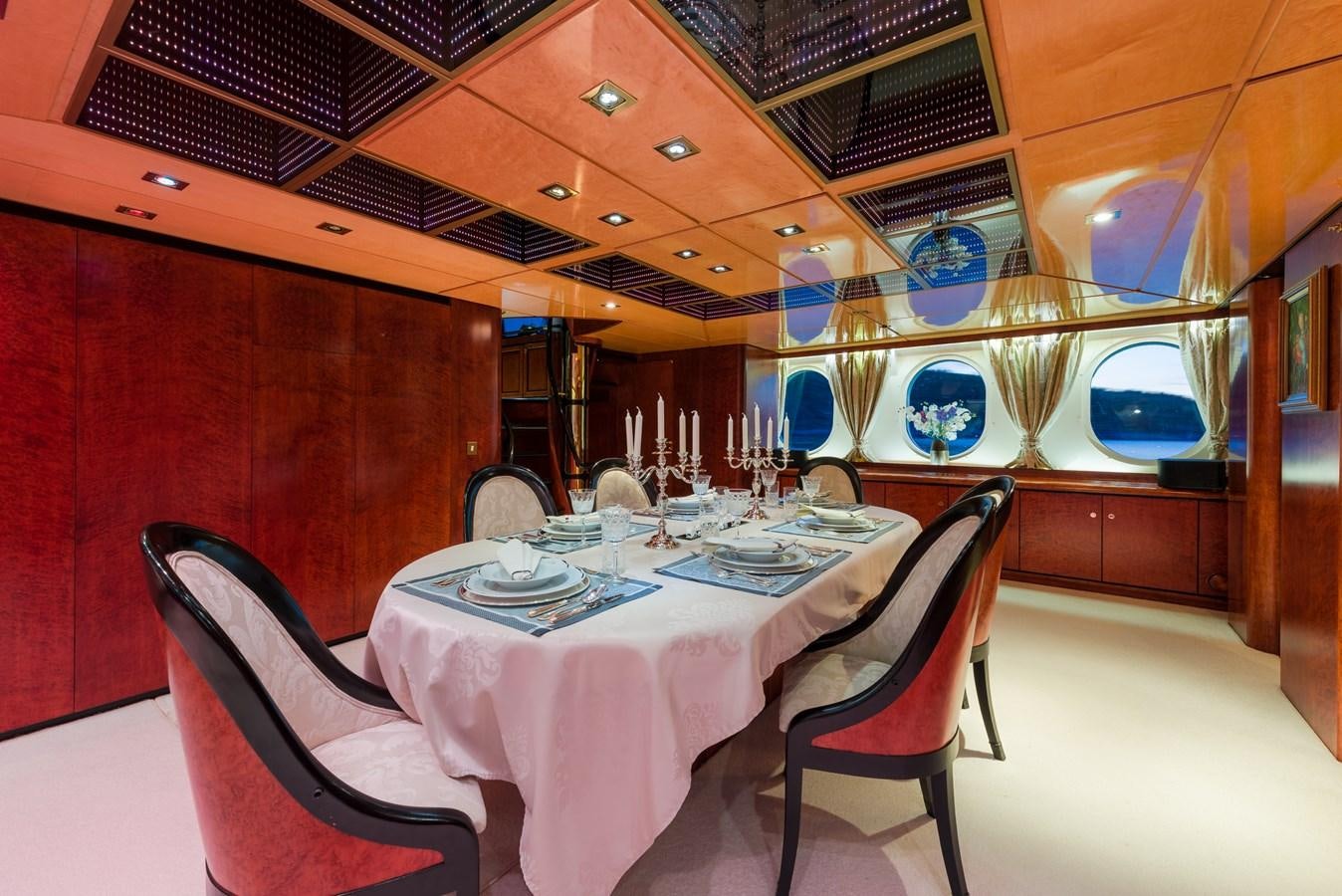 a room with a table and chairs aboard LADY SUNSHINE Yacht for Sale