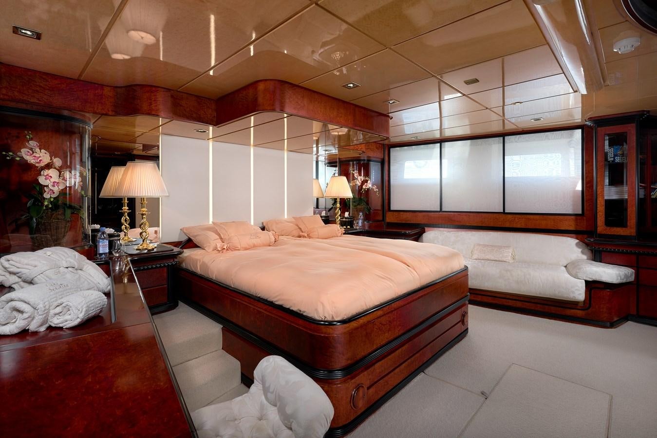 a room with a bed and a large mirror aboard LADY SUNSHINE Yacht for Sale
