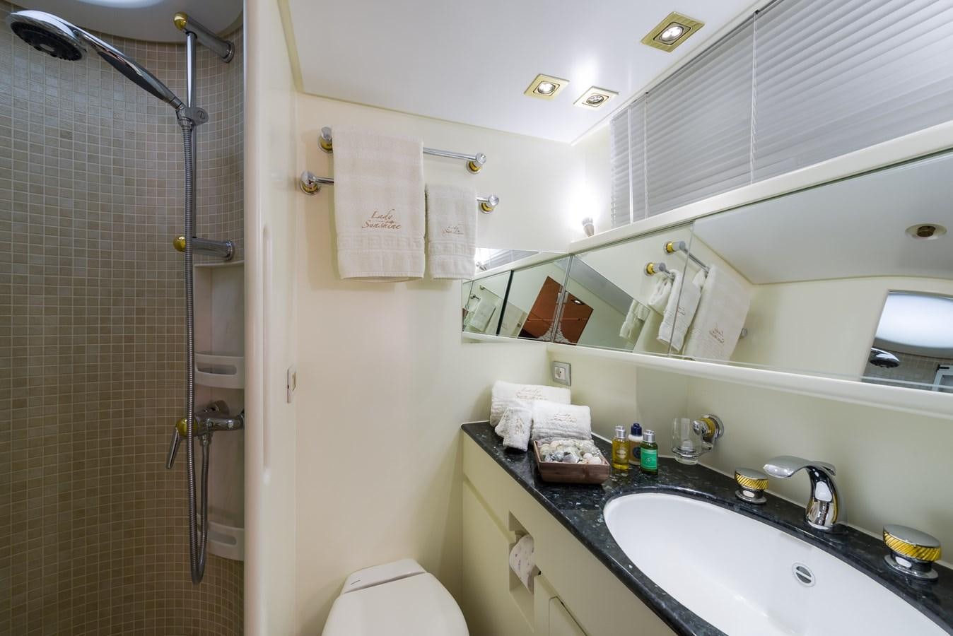 a bathroom with a shower sink and toilet aboard LADY SUNSHINE Yacht for Sale