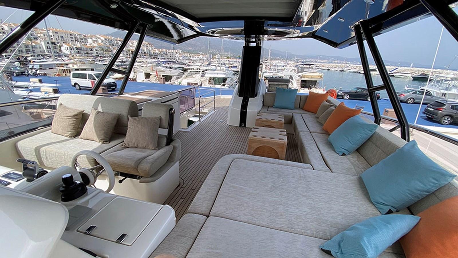 a boat with a couch and a table on it aboard CAPPUCCINO Yacht for Sale