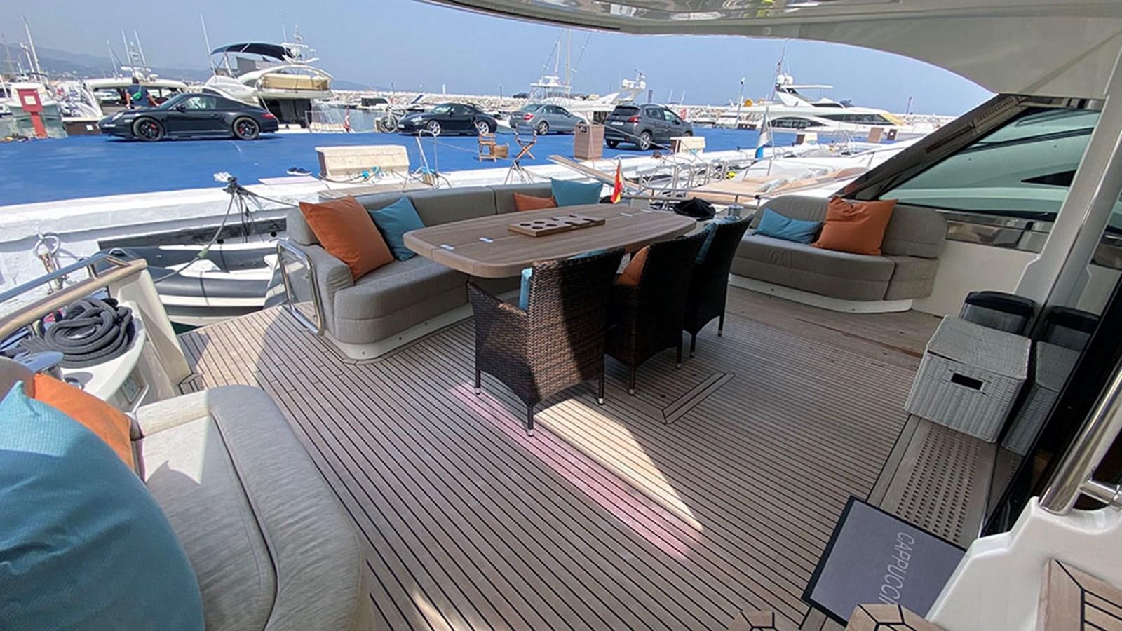 a table and chairs on a boat aboard CAPPUCCINO Yacht for Sale