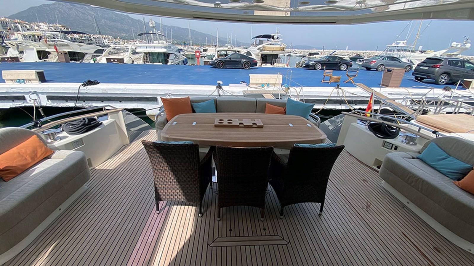 a table on a deck overlooking a marina aboard CAPPUCCINO Yacht for Sale