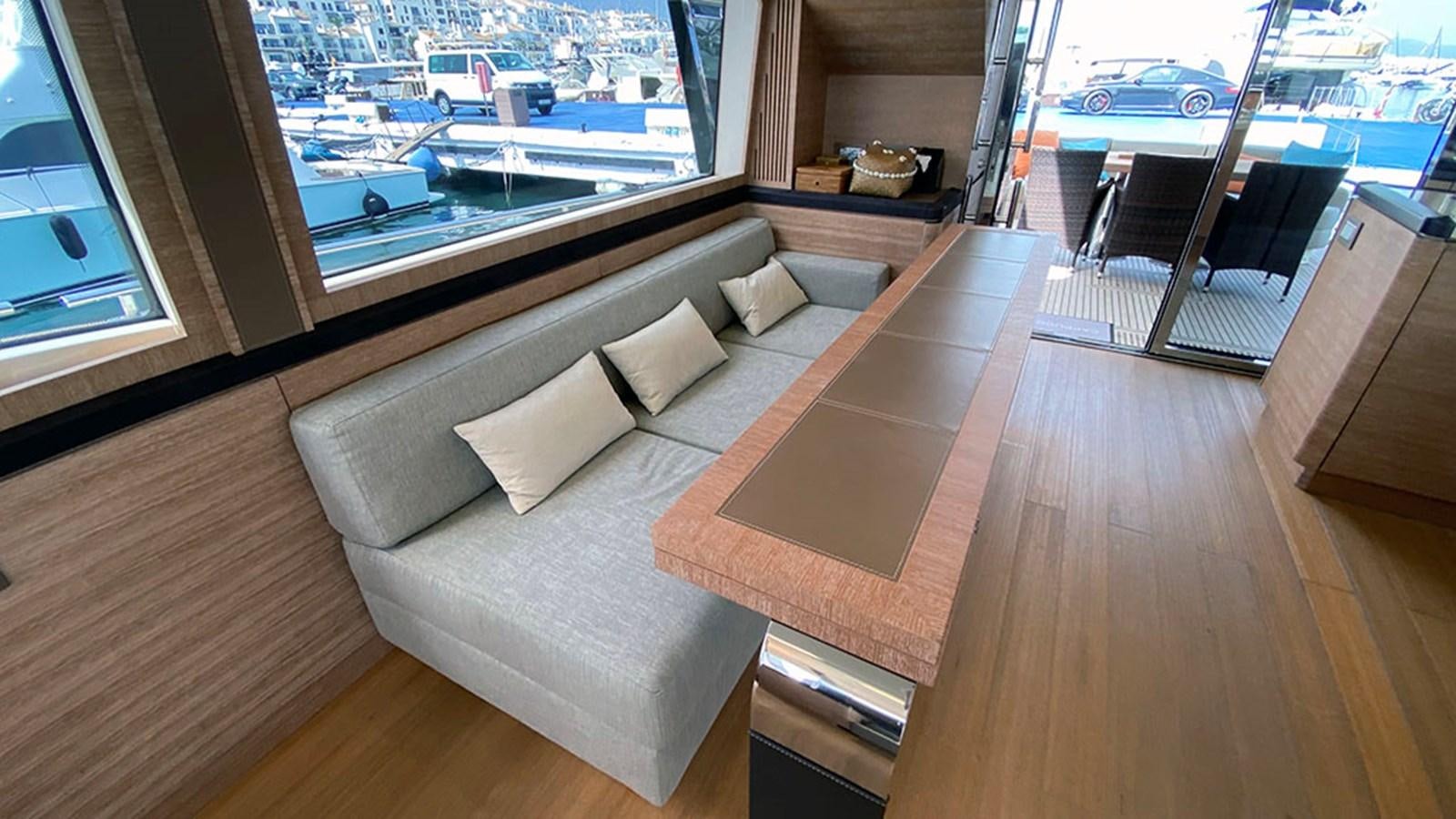 a living room with a large window aboard CAPPUCCINO Yacht for Sale