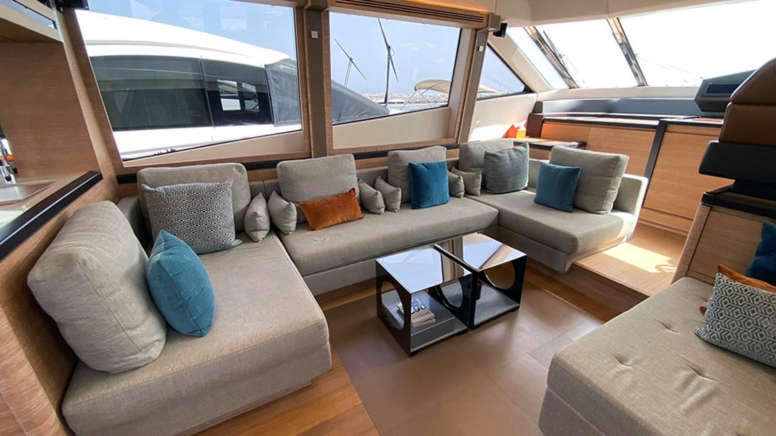 a living room with a couch and a table aboard CAPPUCCINO Yacht for Sale