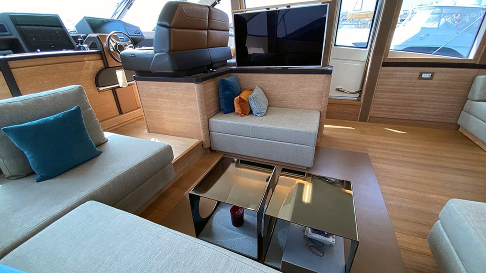 a living room with a couch and a coffee table aboard CAPPUCCINO Yacht for Sale