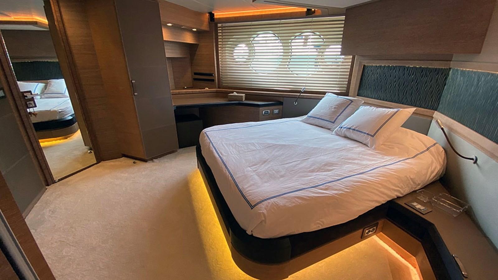 a room with a bed and desk aboard CAPPUCCINO Yacht for Sale
