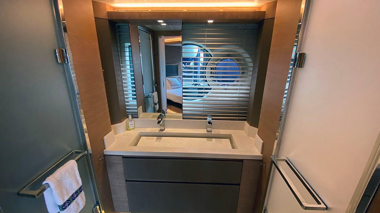 a bathroom with a sink and a mirror aboard CAPPUCCINO Yacht for Sale