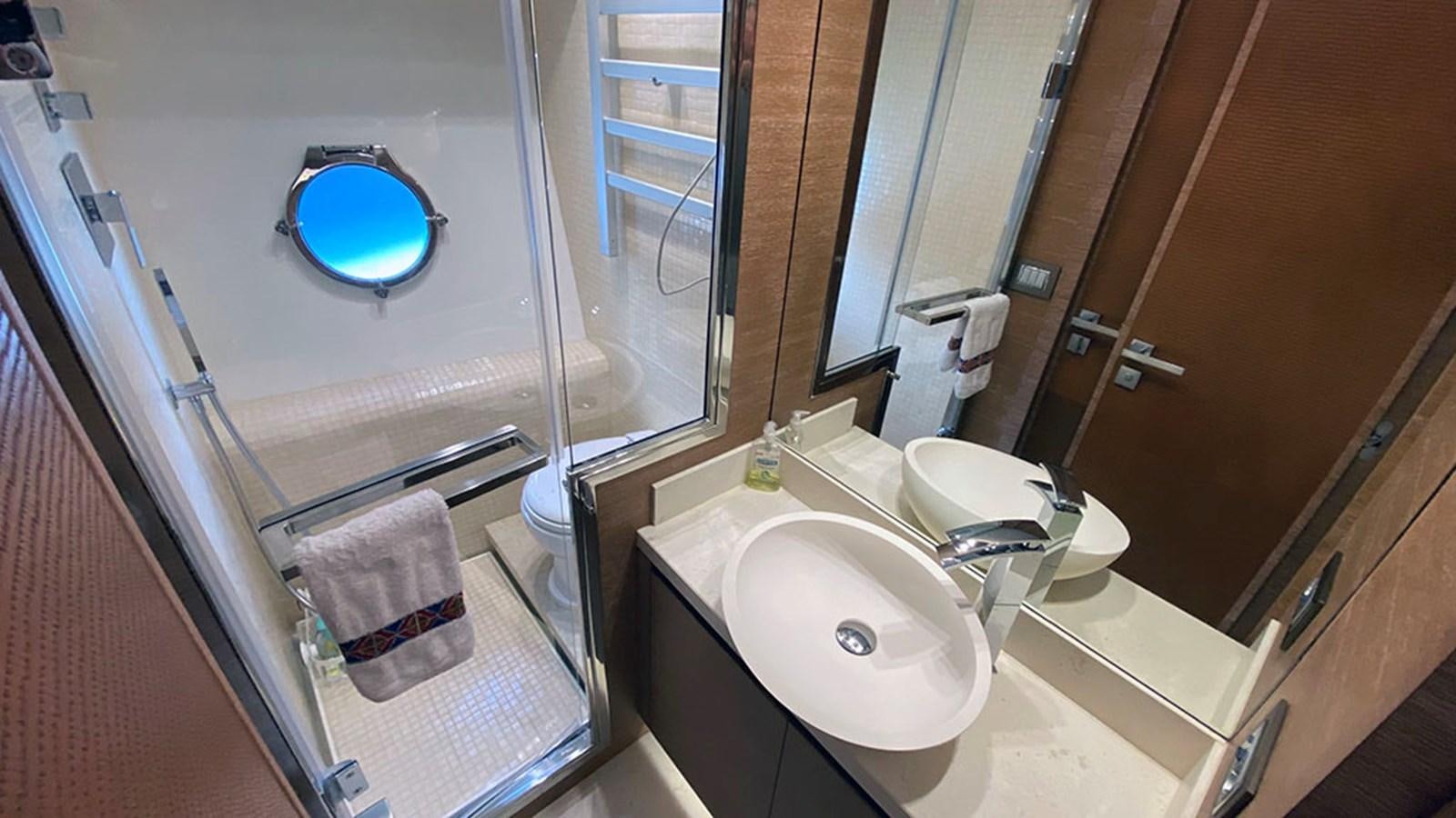 a bathroom with a sink and a bathtub aboard CAPPUCCINO Yacht for Sale