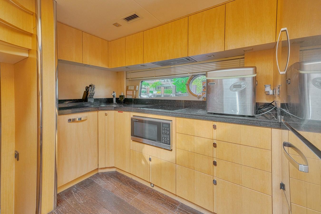 a kitchen with wooden cabinets aboard MISS INGRID Yacht for Sale