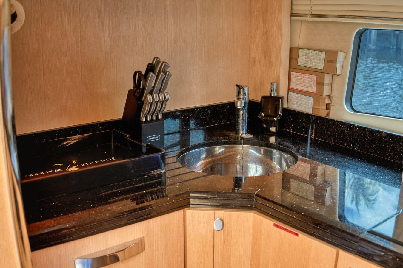 a kitchen counter with a sink and a window aboard MISS INGRID Yacht for Sale