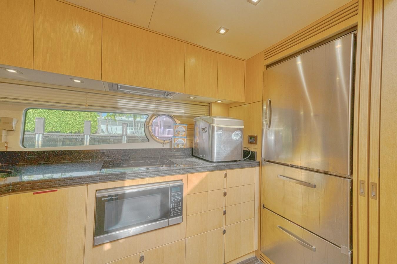 a kitchen with wooden cabinets aboard MISS INGRID Yacht for Sale