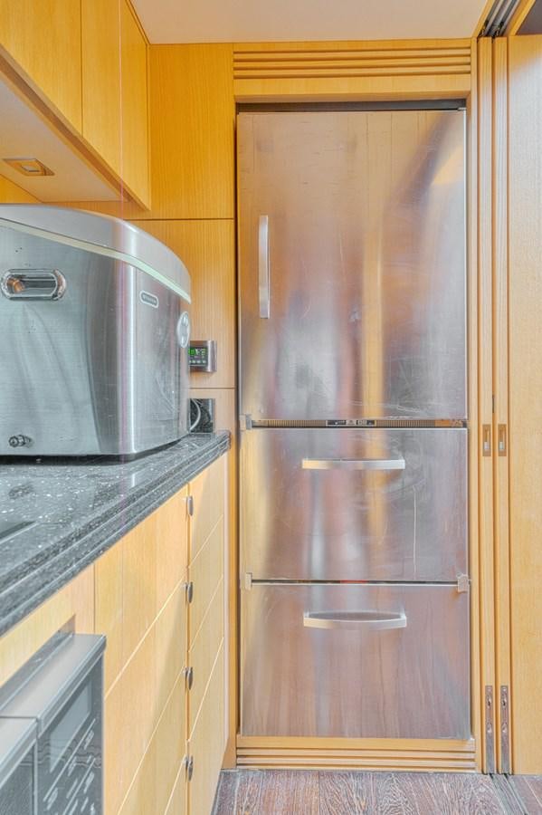 a kitchen with a microwave and cabinets aboard MISS INGRID Yacht for Sale
