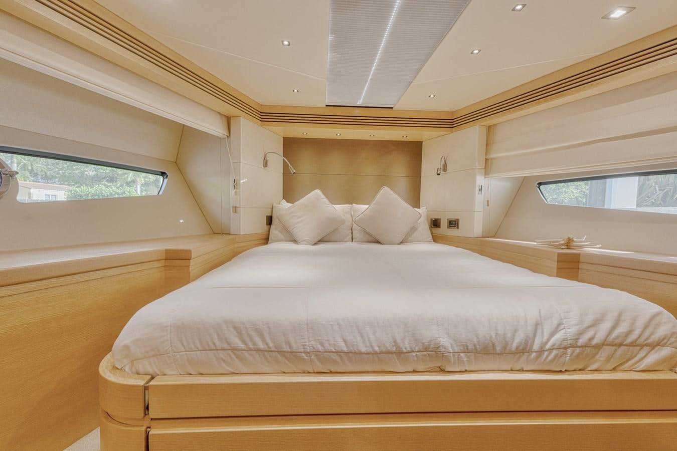 a bed with white sheets aboard MISS INGRID Yacht for Sale