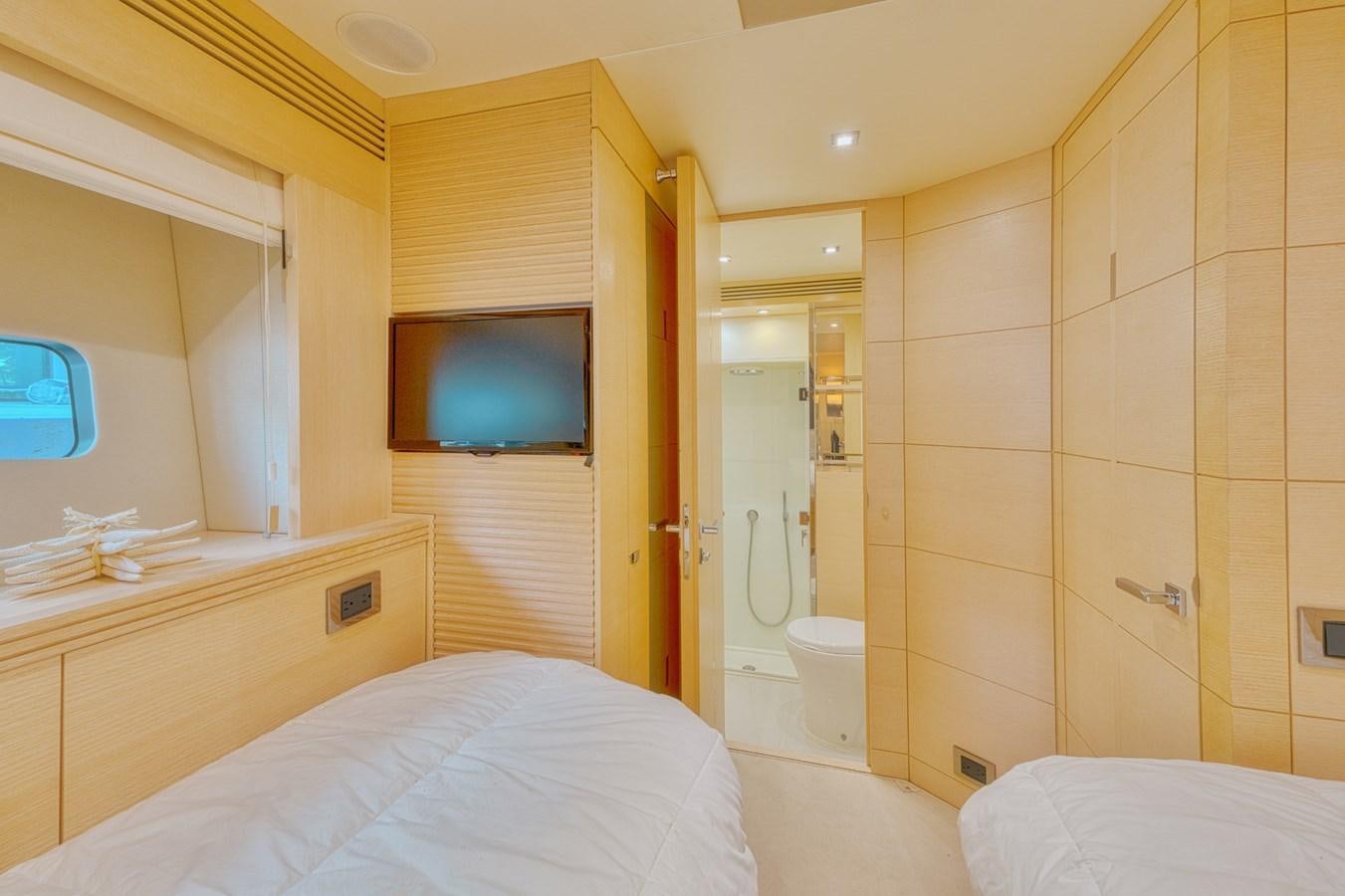 a bathroom with a tv on the wall aboard MISS INGRID Yacht for Sale