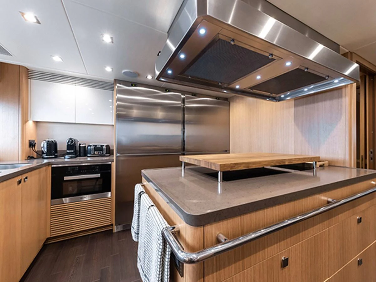 a kitchen with a stainless steel refrigerator aboard ELYSIUM Yacht for Sale