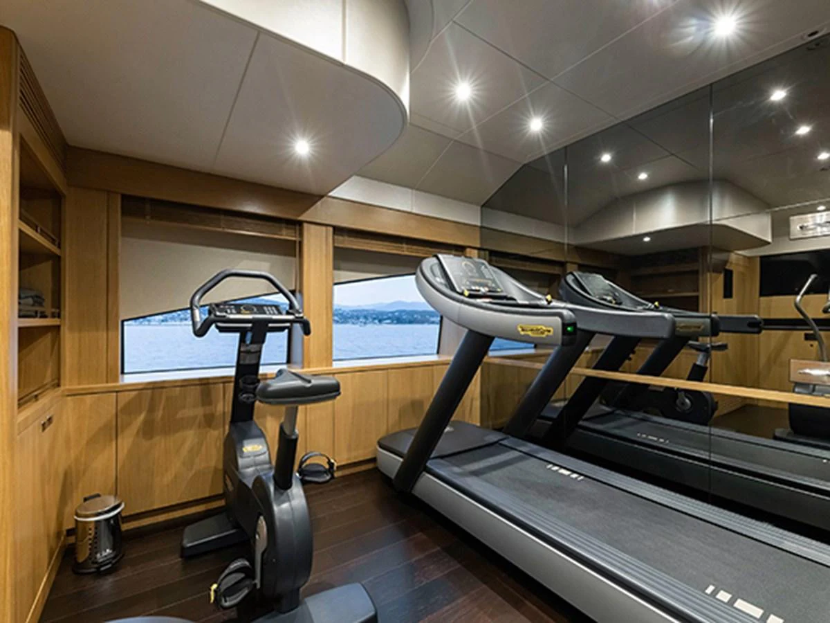a gym with a large mirror aboard ELYSIUM Yacht for Sale
