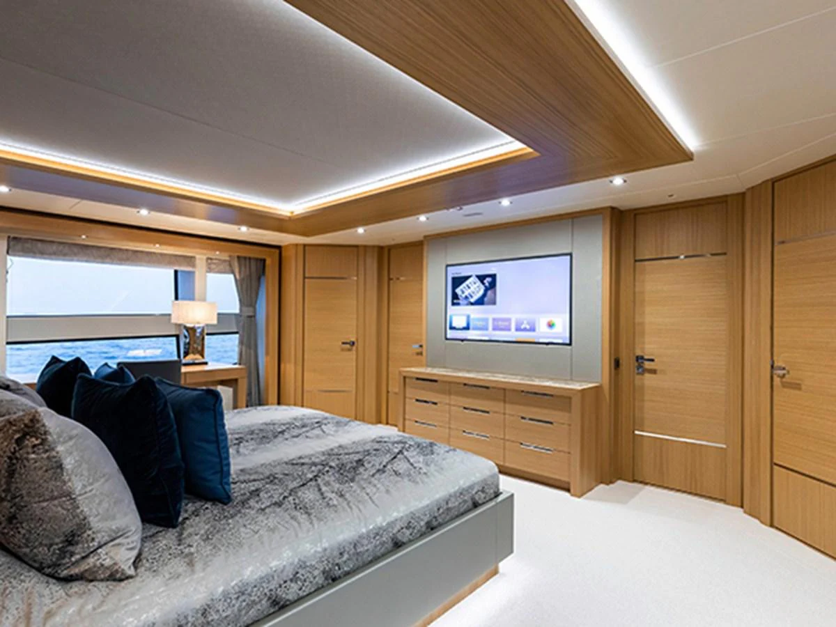 a bedroom with a bed and a tv aboard ELYSIUM Yacht for Sale