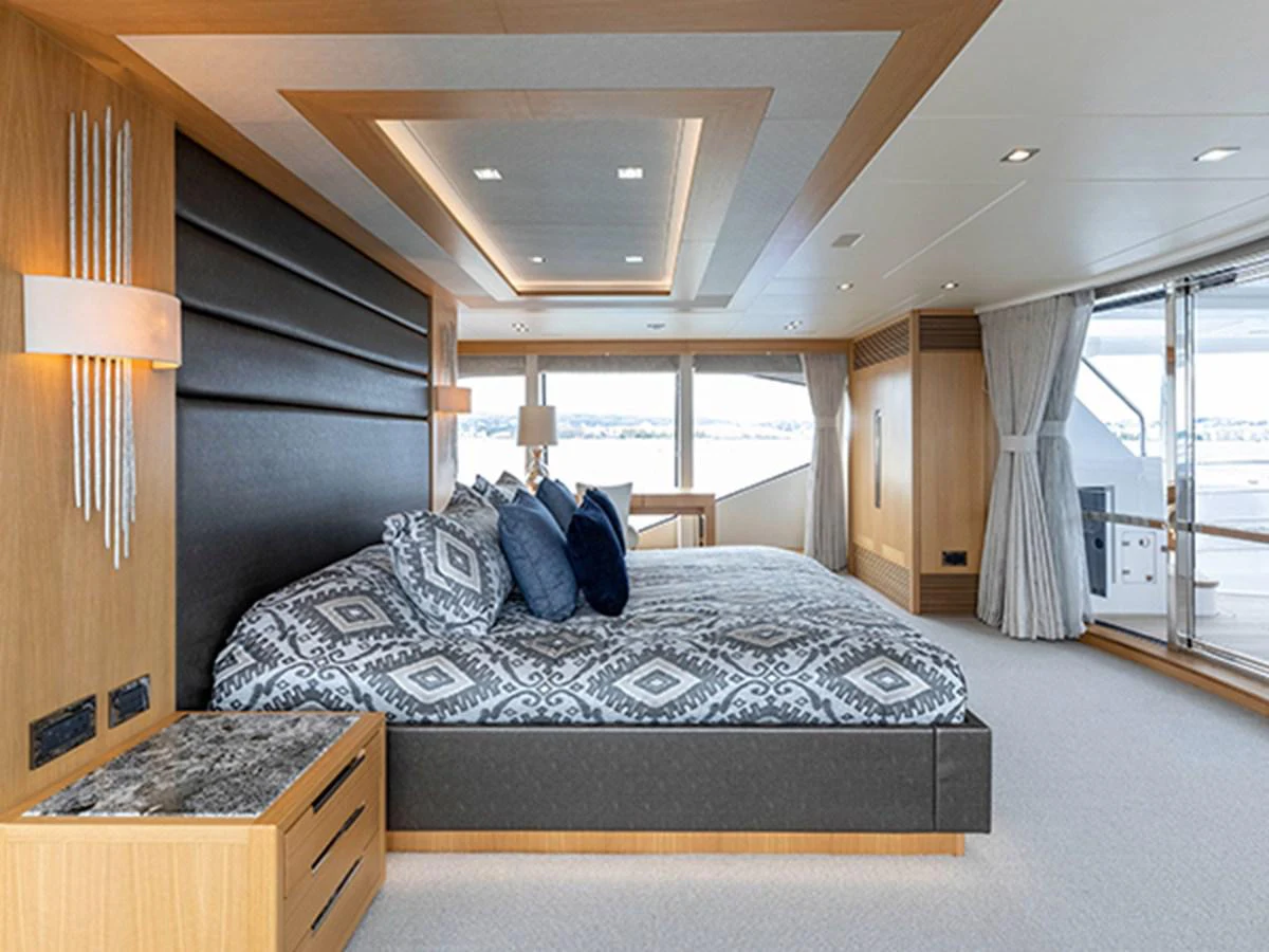 a bedroom with a large bed aboard ELYSIUM Yacht for Sale